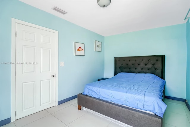 bedroom with light tile patterned flooring