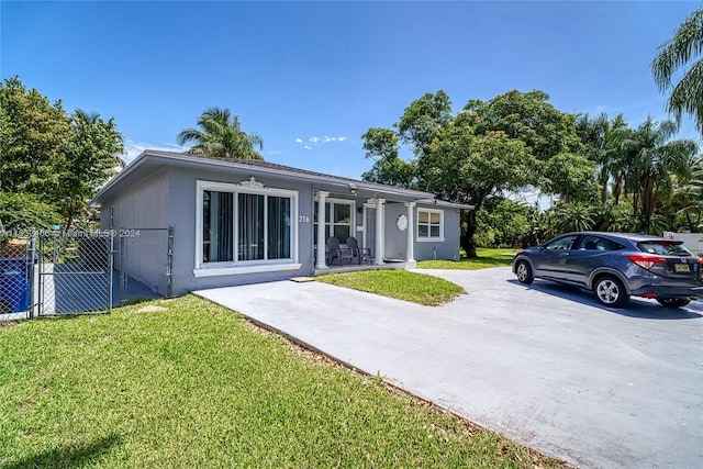 216 SW 6th St, Hallandale Beach, FL 33009 - exterior space with stucco siding, fence, and a yard