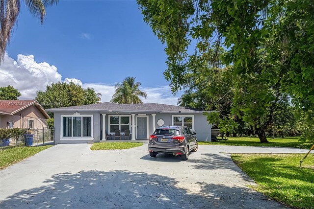 216 SW 6th St, Hallandale Beach, FL 33009 - ranch-style home featuring driveway, stucco siding, fence, and a front lawn