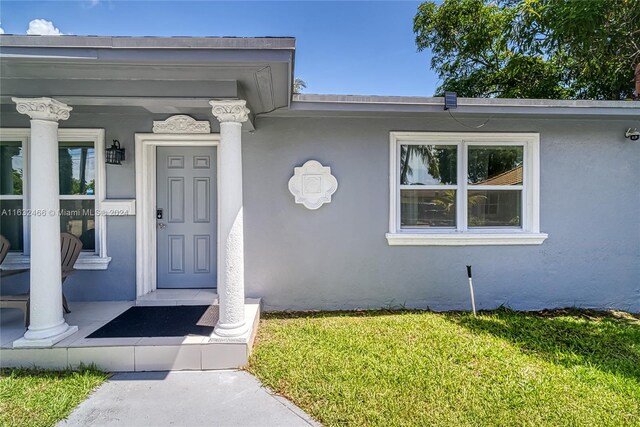 doorway to property with a yard