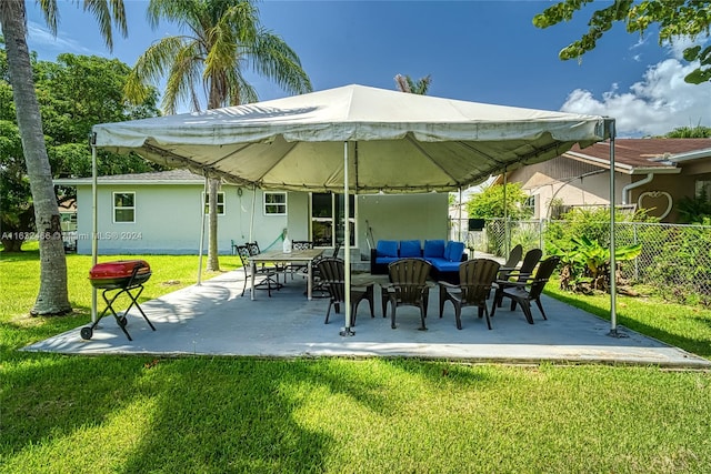 rear view of house with an outdoor living space, a lawn, and a patio area