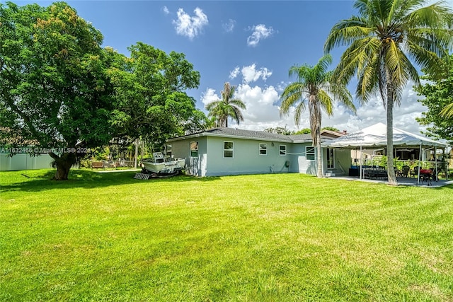 216 SW 6th St, Hallandale Beach, FL 33009 - rear view of house with a yard, stucco siding, a gazebo, and a patio area