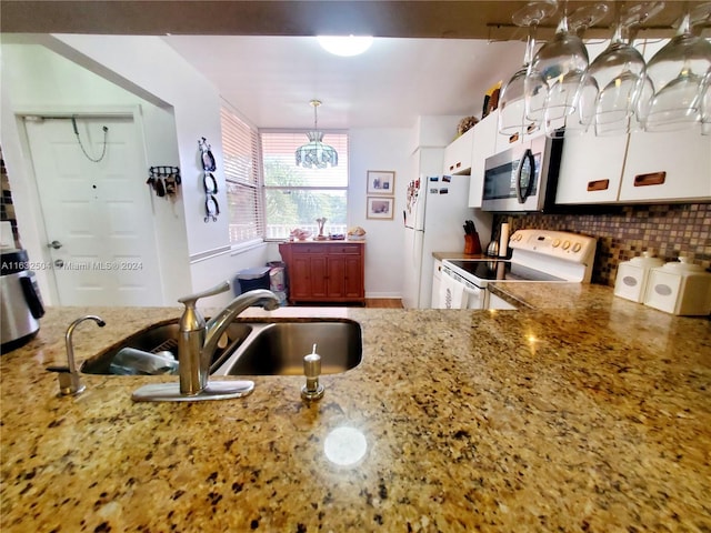 kitchen featuring sink, white cabinetry, white electric range oven, and light stone countertops