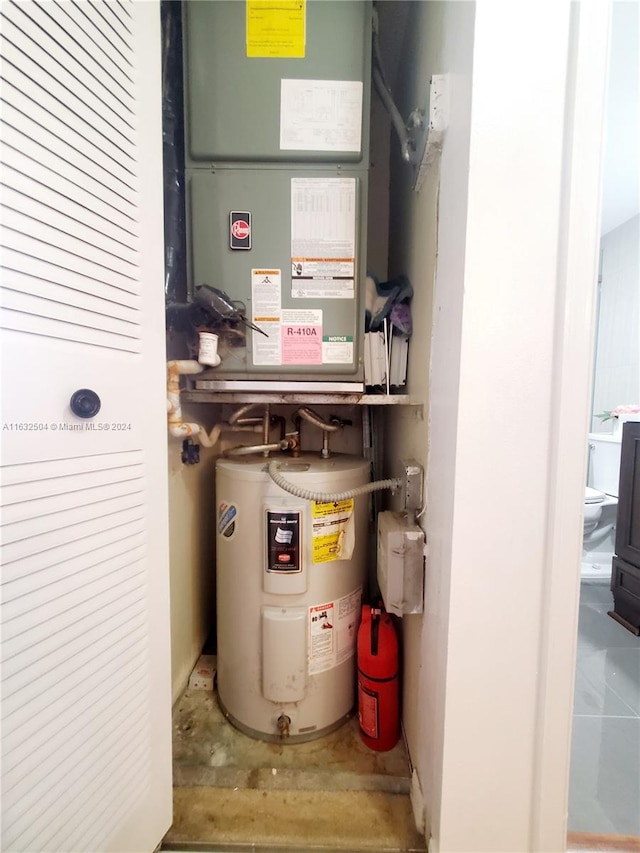 utility room featuring water heater and heating unit