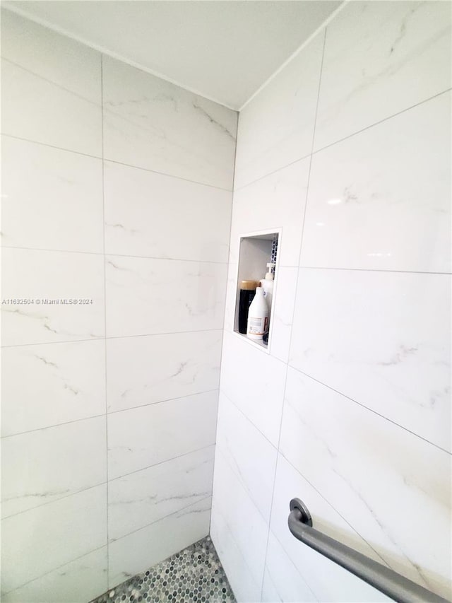 bathroom with tiled shower