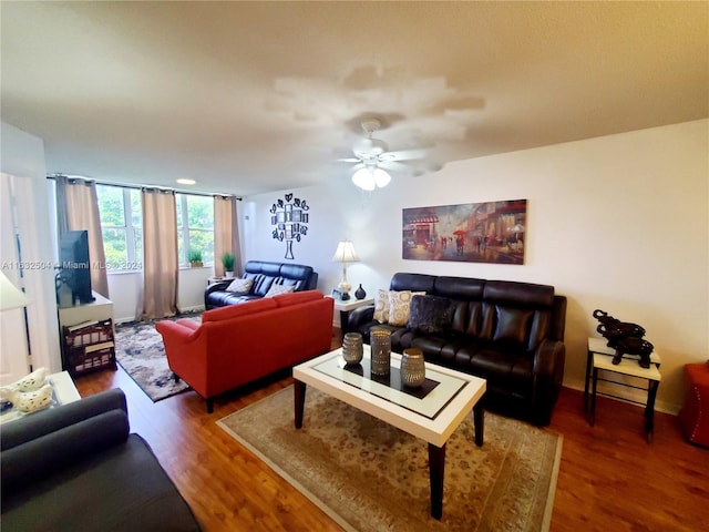 living room featuring hardwood / wood-style floors and ceiling fan