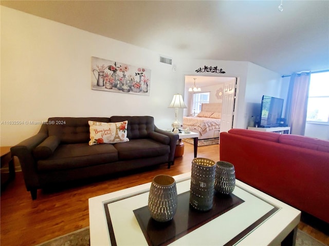 living room featuring an inviting chandelier and hardwood / wood-style floors