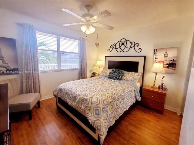 bedroom with ceiling fan and wood-type flooring