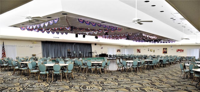 carpeted dining room with ceiling fan