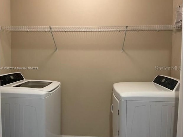 clothes washing area featuring separate washer and dryer