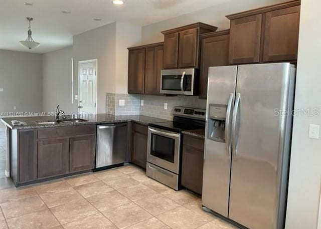 kitchen featuring stainless steel appliances, sink, kitchen peninsula, backsplash, and light tile patterned floors