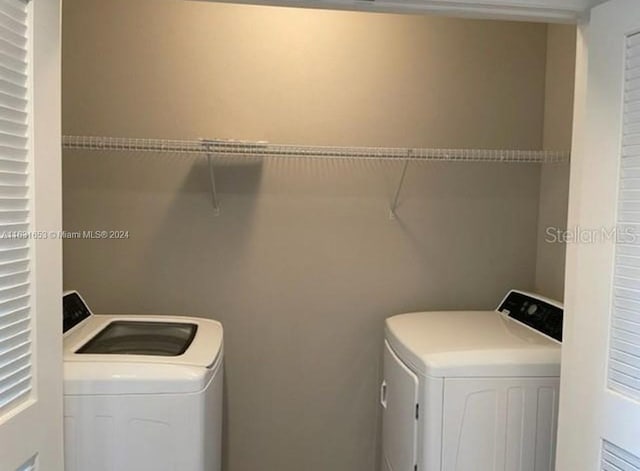 laundry room with washing machine and clothes dryer