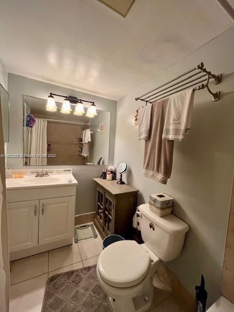 bathroom with tile patterned floors, toilet, and vanity