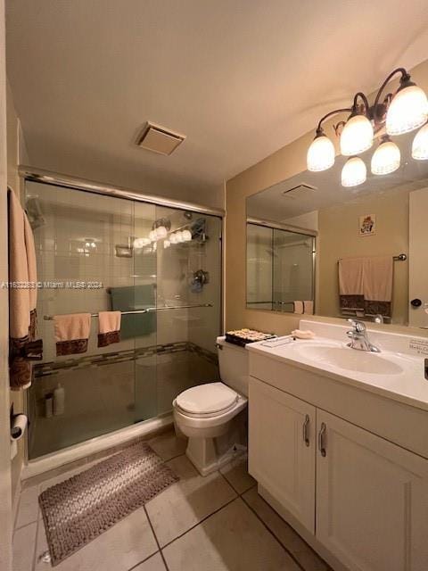 bathroom featuring a shower with door, tile patterned floors, toilet, and vanity