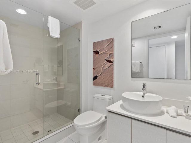 bathroom with vanity, tile patterned floors, walk in shower, and toilet