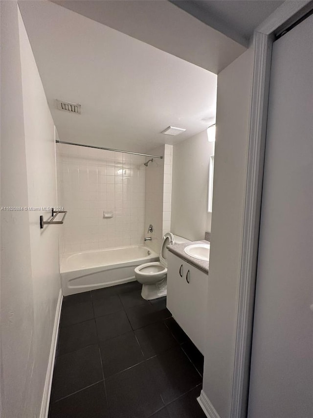 full bathroom with tile patterned floors, toilet, vanity, and tiled shower / bath