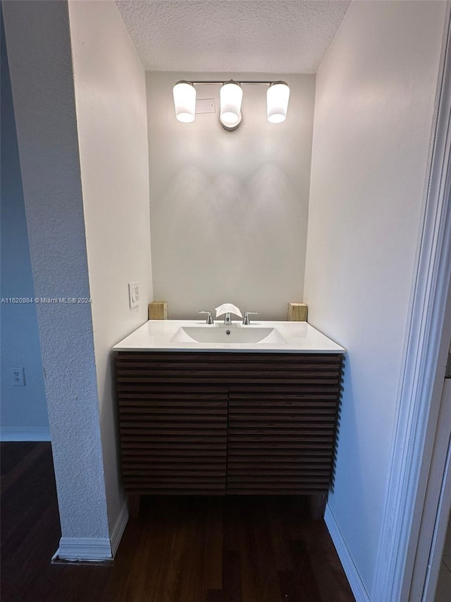 bathroom featuring sink, a textured ceiling, and wood-type flooring