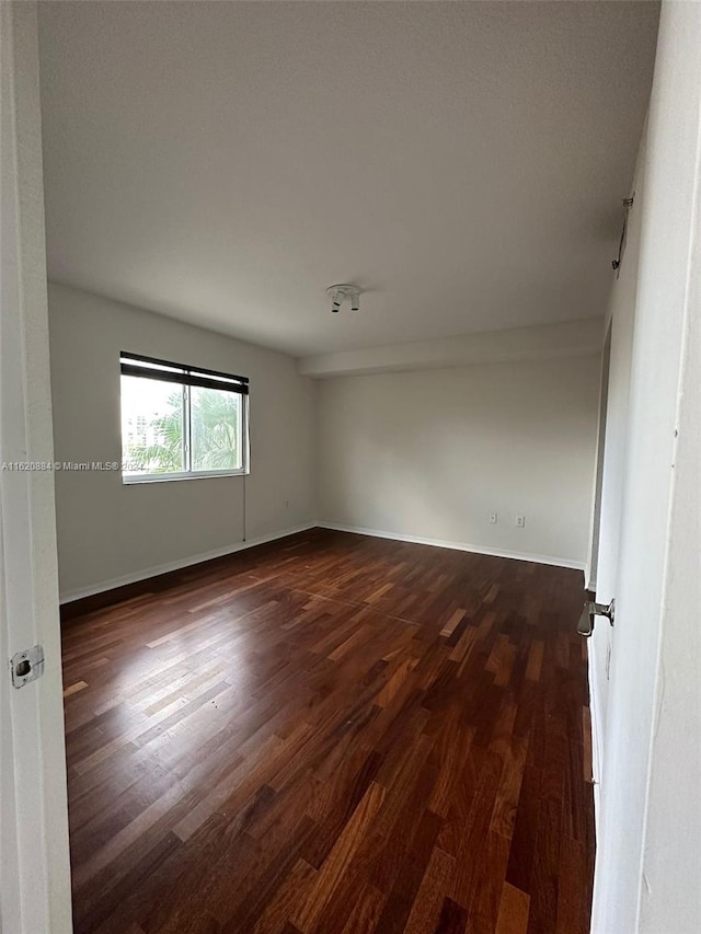 unfurnished room featuring dark hardwood / wood-style floors