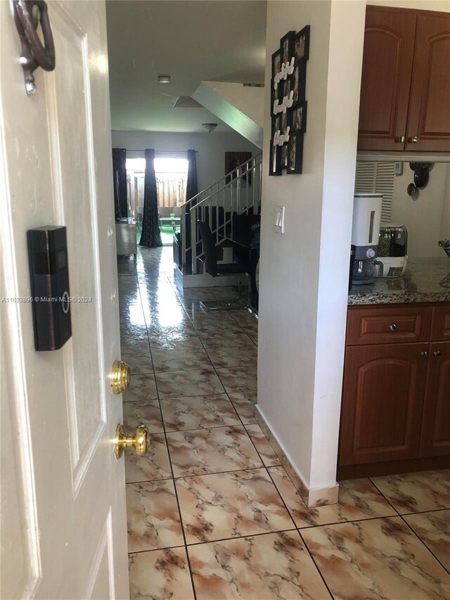 hall featuring light tile patterned floors