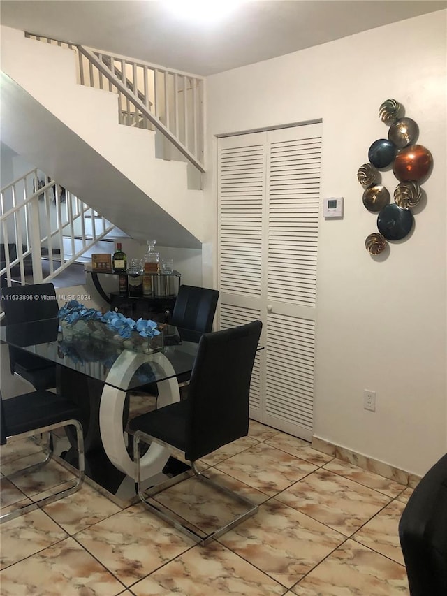 16700 NW 55th Ave Unit 12, Miami Gardens, FL 33055 - dining area featuring baseboards and stairs