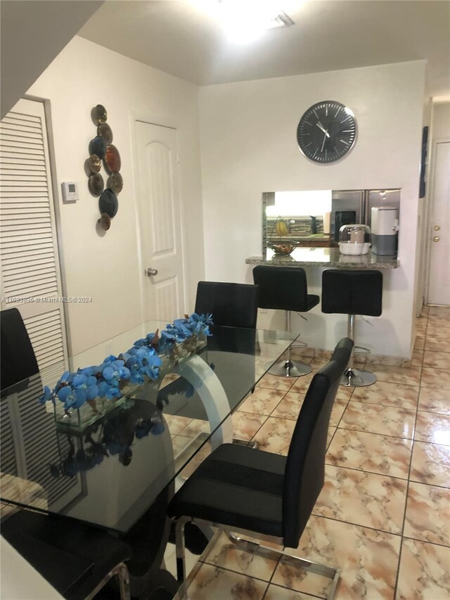 dining area with light tile patterned floors