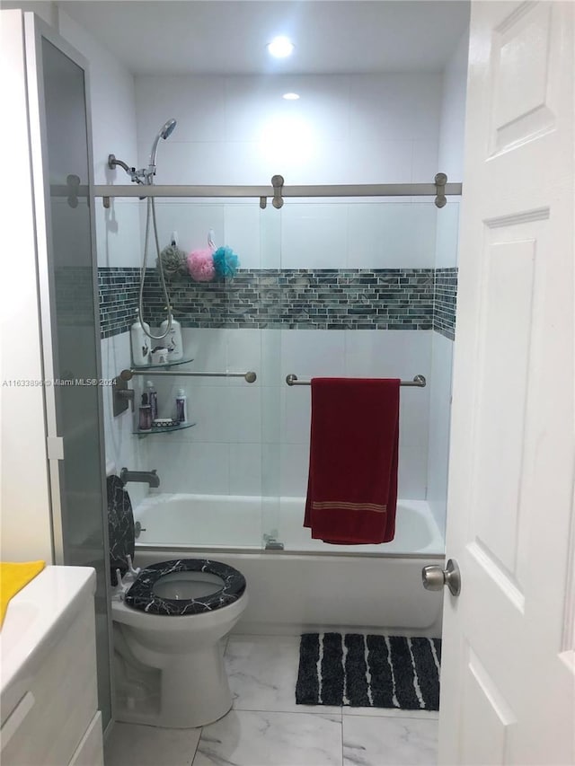 16700 NW 55th Ave Unit 12, Miami Gardens, FL 33055 - bathroom featuring marble finish floor, combined bath / shower with glass door, and toilet