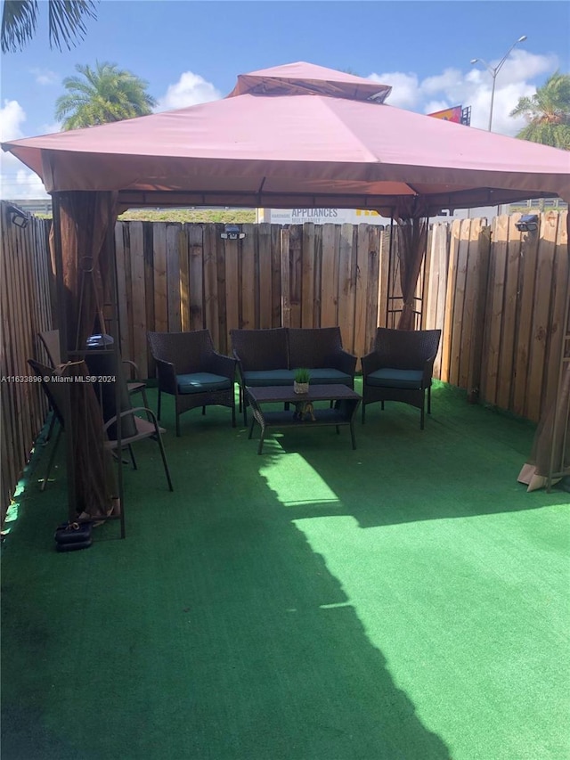 16700 NW 55th Ave Unit 12, Miami Gardens, FL 33055 - view of patio / terrace featuring outdoor lounge area, fence, and a gazebo