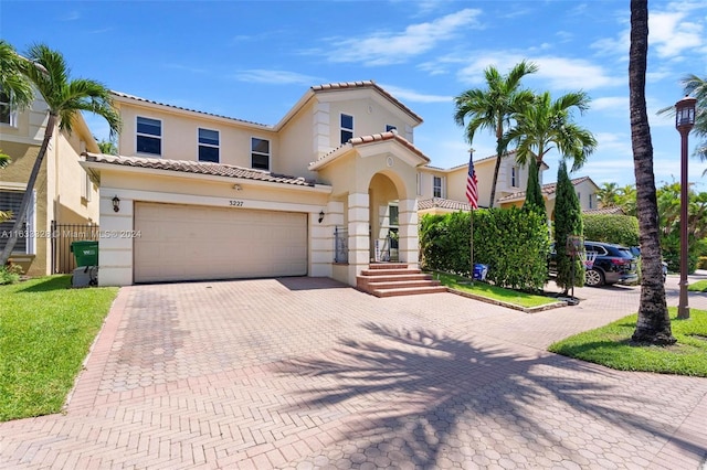 mediterranean / spanish-style house with a garage