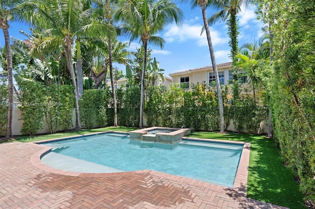 view of swimming pool with an in ground hot tub