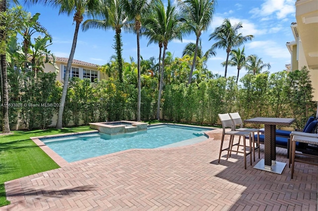 view of swimming pool with an in ground hot tub and a patio area