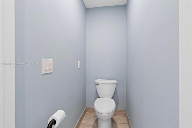 bathroom featuring hardwood / wood-style flooring and toilet