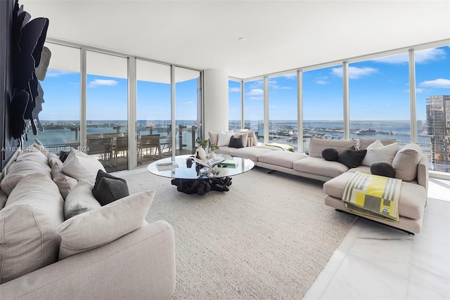 living room featuring a water view, tile patterned flooring, and floor to ceiling windows