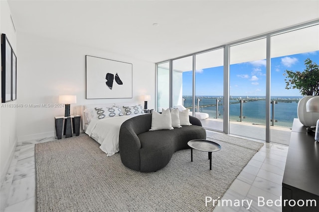 bedroom featuring floor to ceiling windows, a water view, access to exterior, and baseboards