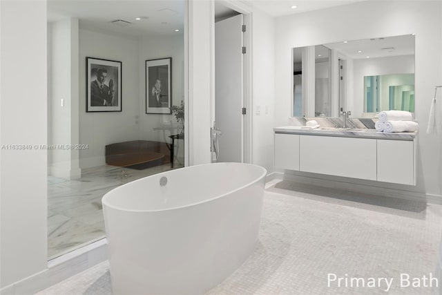 full bath featuring a soaking tub, recessed lighting, and vanity