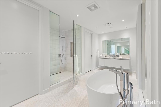 bathroom with vanity, tile patterned floors, and separate shower and tub