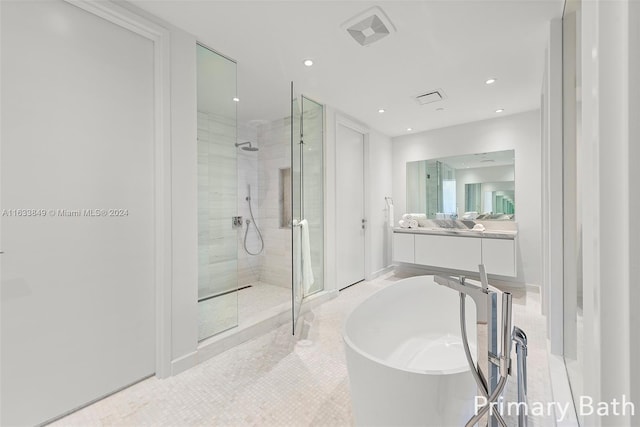 bathroom featuring visible vents, a freestanding tub, recessed lighting, vanity, and a stall shower