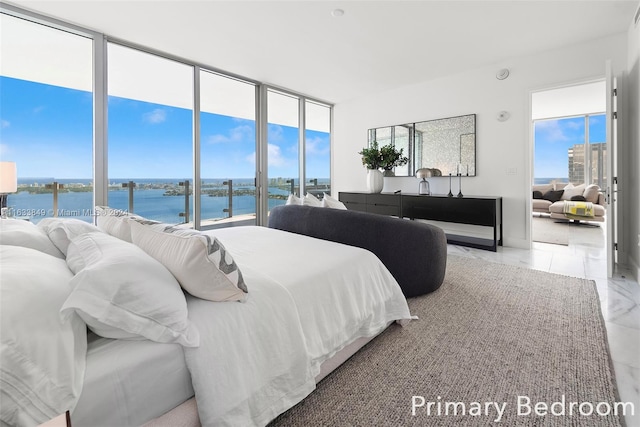 bedroom with a water view and light tile patterned floors