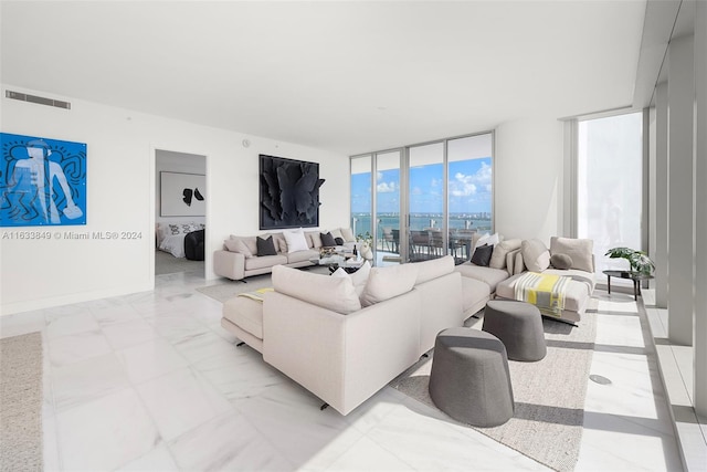 living room with light tile patterned floors and floor to ceiling windows