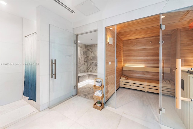 full bathroom featuring a sauna, tile patterned floors, and a shower stall