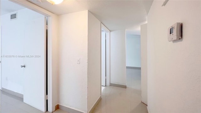 hallway with light tile patterned floors