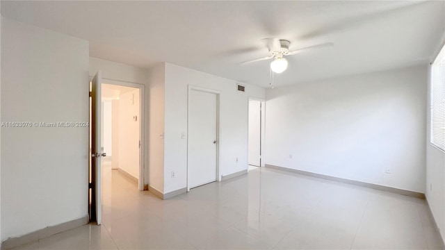 spare room with tile patterned floors and ceiling fan