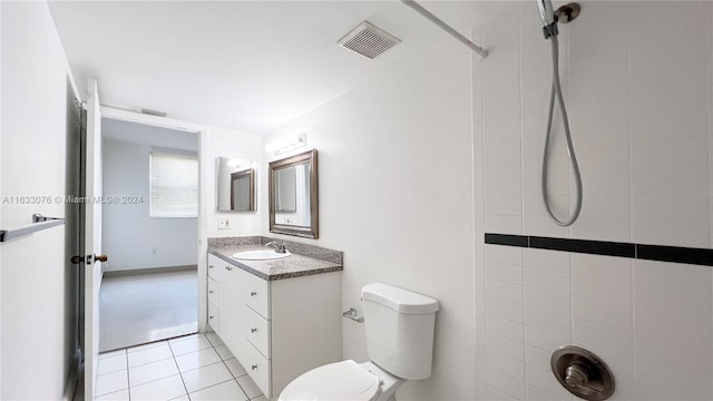 bathroom featuring vanity, tile patterned flooring, and toilet