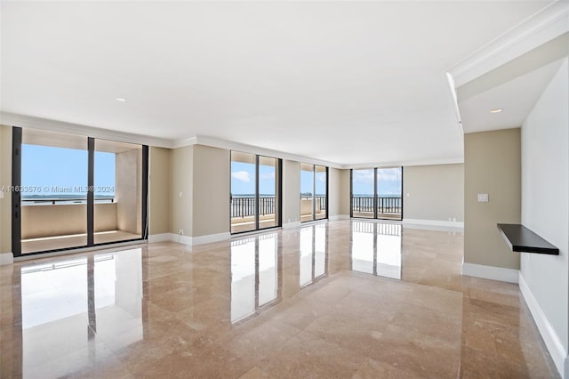 empty room with baseboards and floor to ceiling windows