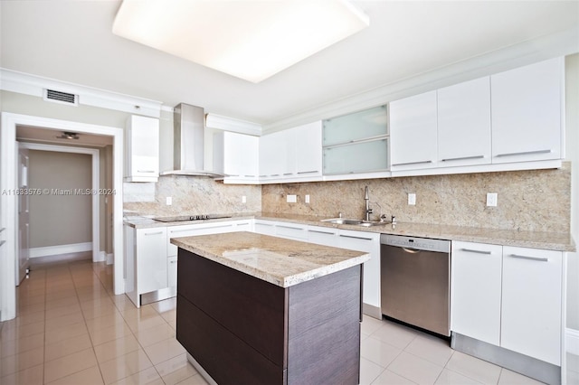 kitchen featuring stainless steel dishwasher, light tile patterned flooring, tasteful backsplash, wall chimney range hood, and sink