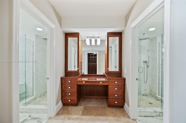 bathroom featuring baseboards, a shower stall, and vanity