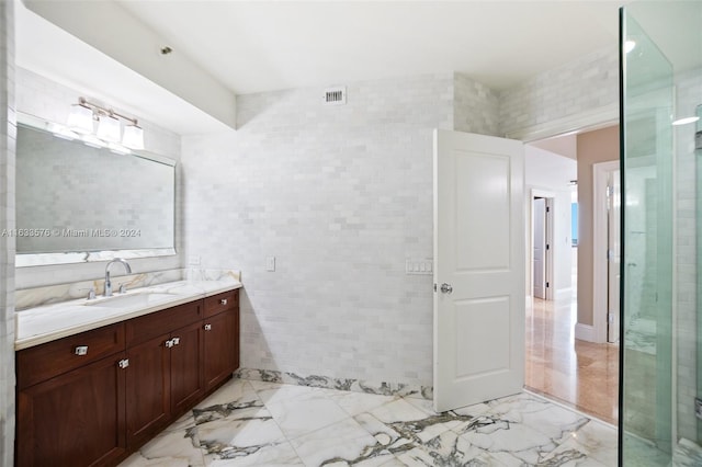 bathroom with vanity, tile patterned floors, and tile walls