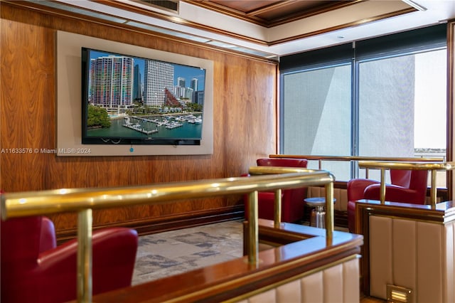 home theater featuring wooden walls and ornamental molding