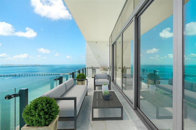 balcony featuring a water view and outdoor lounge area