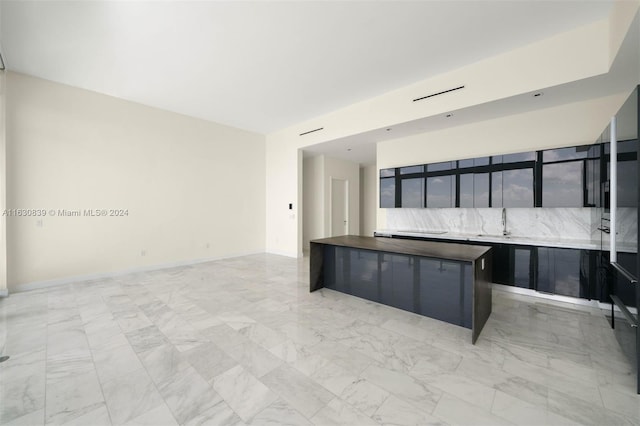 kitchen with sink, backsplash, and wood counters