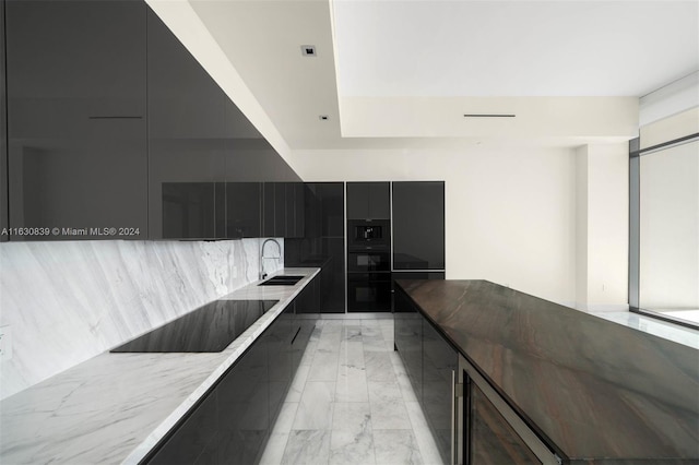 kitchen with tasteful backsplash, black electric stovetop, and sink